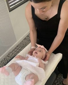 Chiropractor adjusting 3 month old baby
